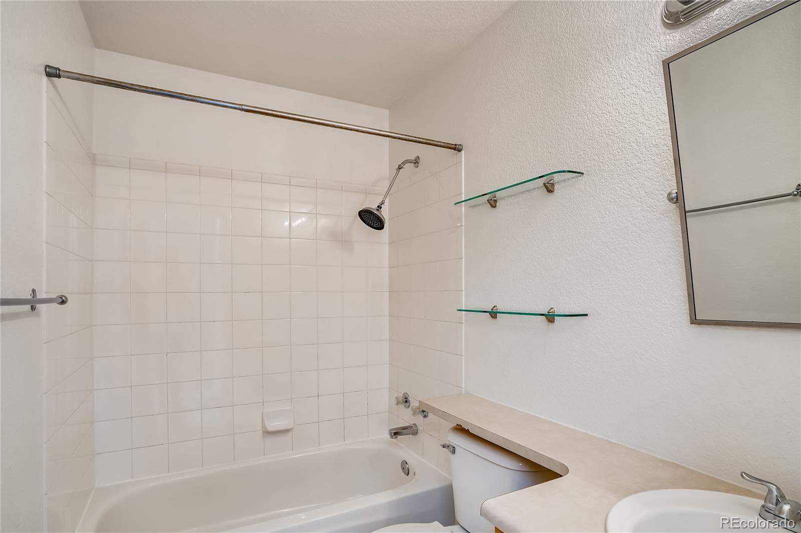 6778 Zenobia Loop, Unit 2 Westminster, CO 80030 - Photo 10 of 13 a bathroom with a shower and toilet