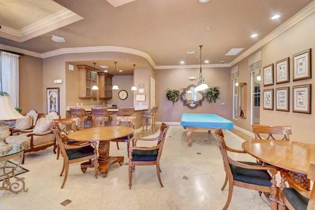 a living room with furniture and large windows