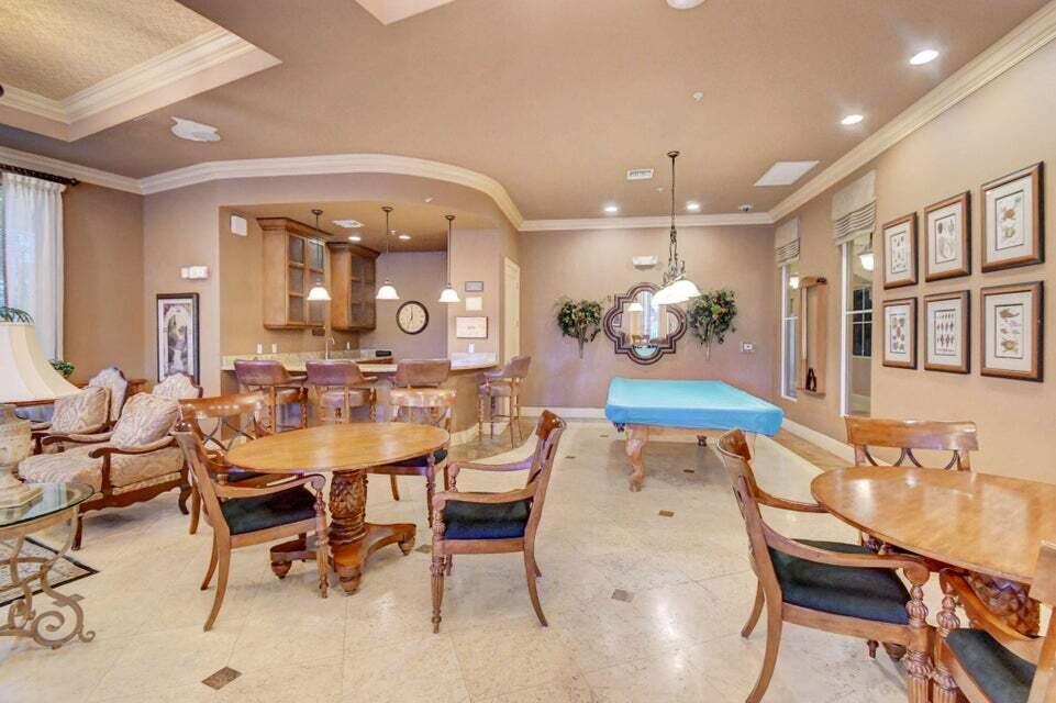 1660 Renaissance Commons Boulevard, Unit 2608 Boynton Beach, FL 33426 - Photo 25 of 31 a view of a dining room with furniture and chandelier