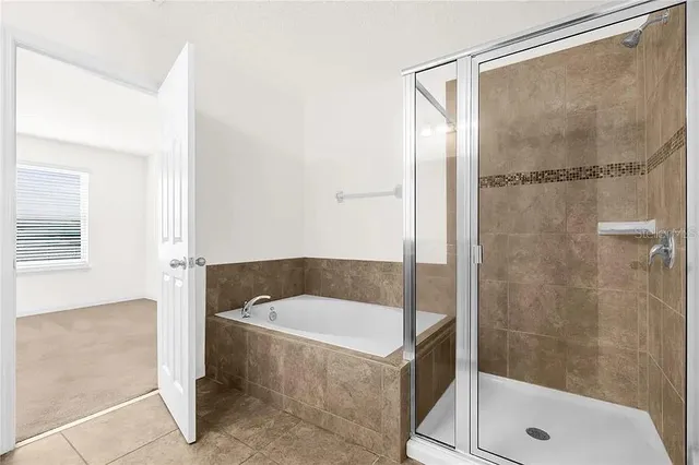 a bathroom with a bathtub and shower