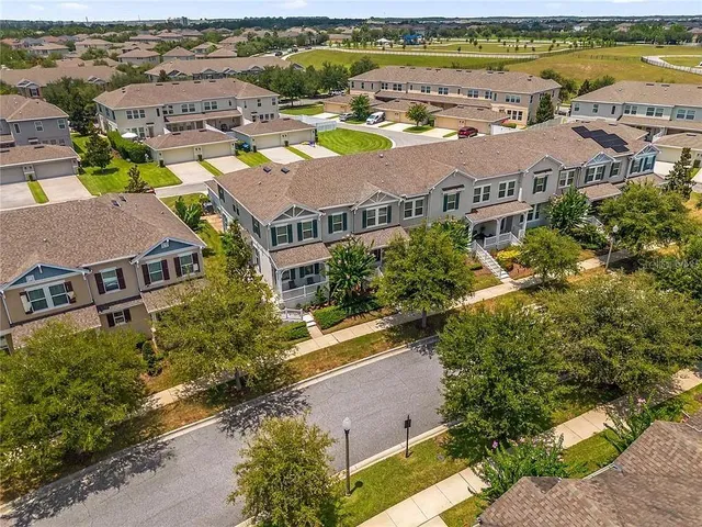 an aerial view of residential houses with outdoor space and river view