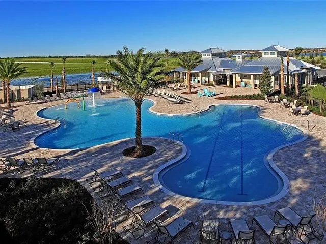 a view of a swimming pool with a yard