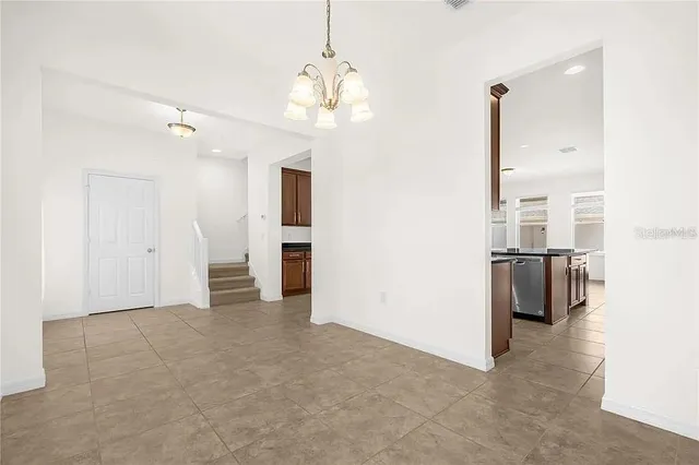 a view of a kitchen with a sink and refrigerator