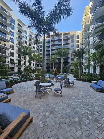 a view of a patio with a table and chairs