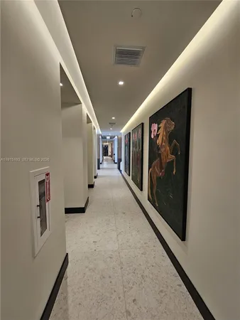 a view of a hallway with stairs