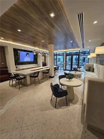 a living room with furniture a rug and a flat screen tv