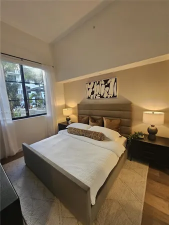 a bedroom with a bed and window