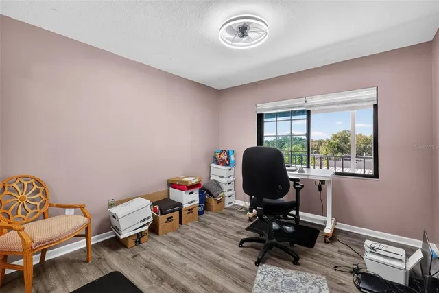 a view of a workspace with furniture and a window