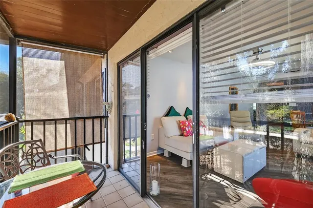 a balcony with furniture and a potted plant