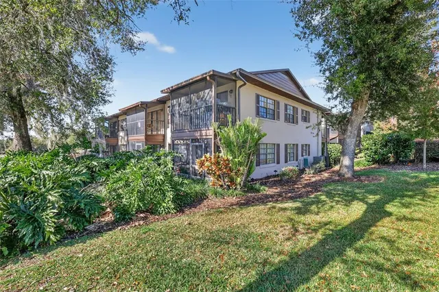 a view of a house with a yard and plants
