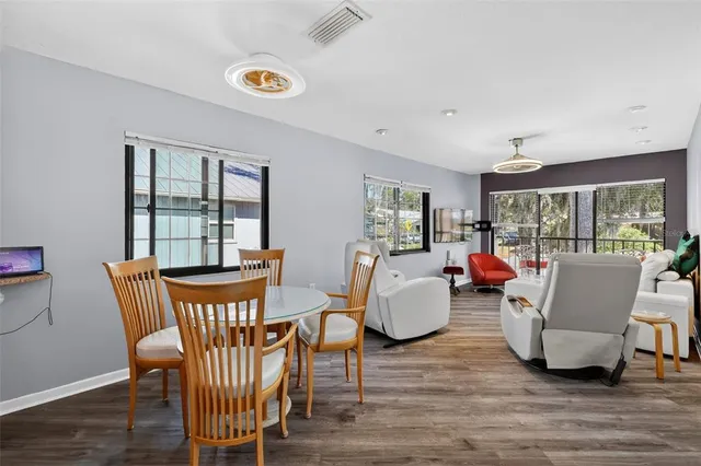 a view of a dining room with furniture a chandelier and wooden floor