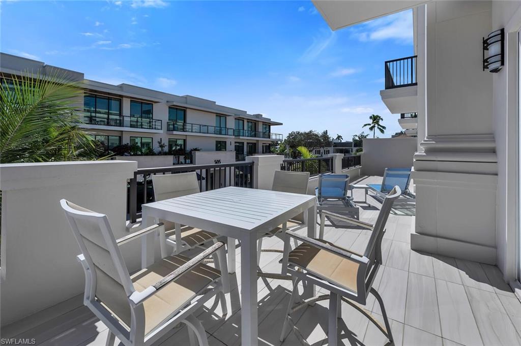 490 5th Street South, Unit 101 Naples, FL 34102 - Photo 11 of 50 a view of a patio with table and chairs