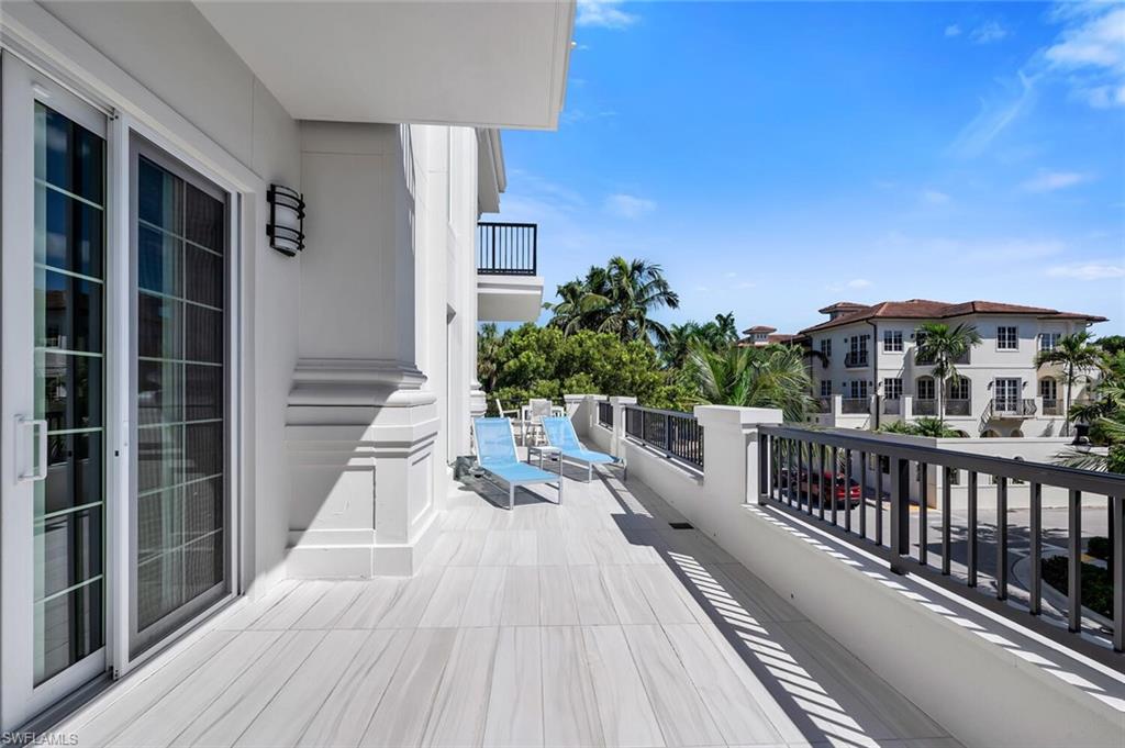 490 5th Street South, Unit 101 Naples, FL 34102 - Photo 12 of 50 a view of balcony with wooden floor and fence