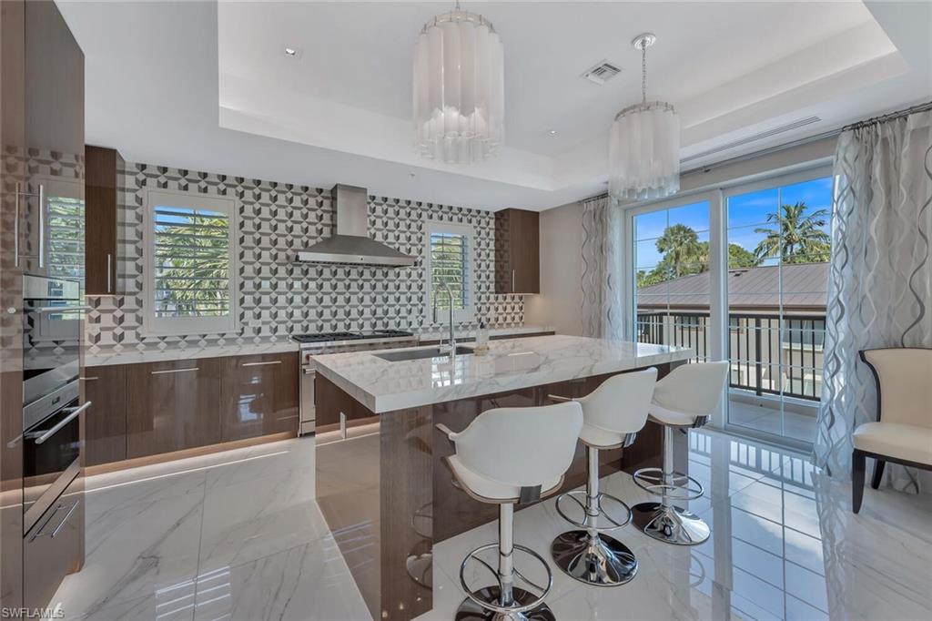 490 5th Street South, Unit 101 Naples, FL 34102 - Photo 14 of 50 a kitchen with a sink cabinets and window