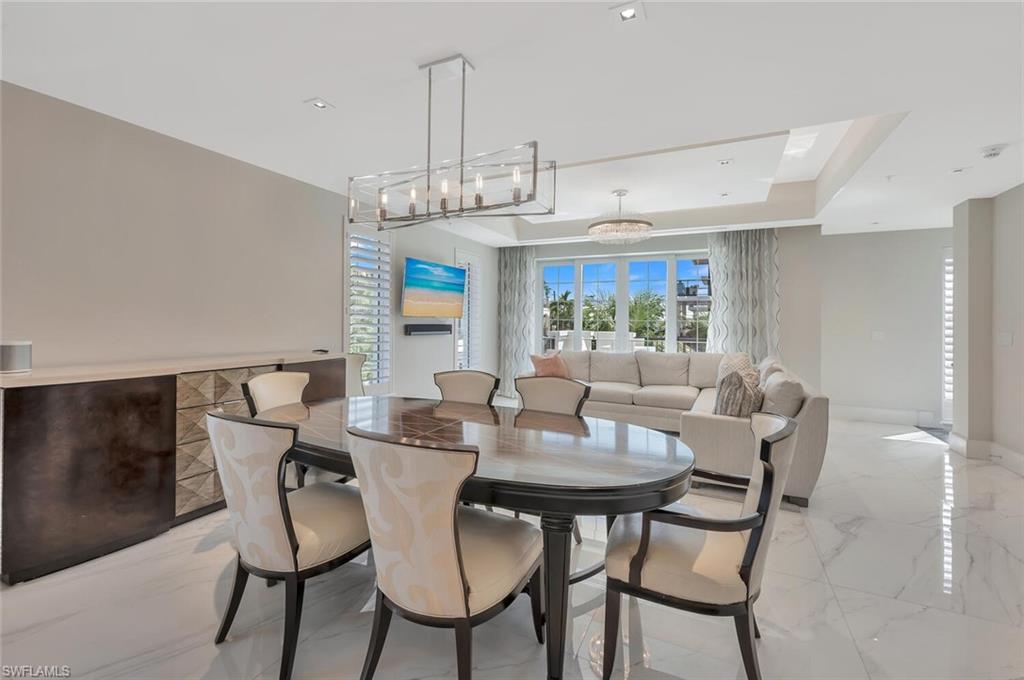 490 5th Street South, Unit 101 Naples, FL 34102 - Photo 21 of 50 a view of a dining room with furniture window and outside view