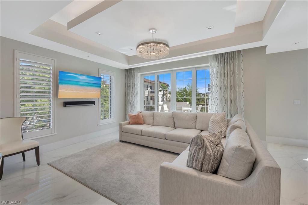 490 5th Street South, Unit 101 Naples, FL 34102 - Photo 23 of 50 a living room with furniture and a window