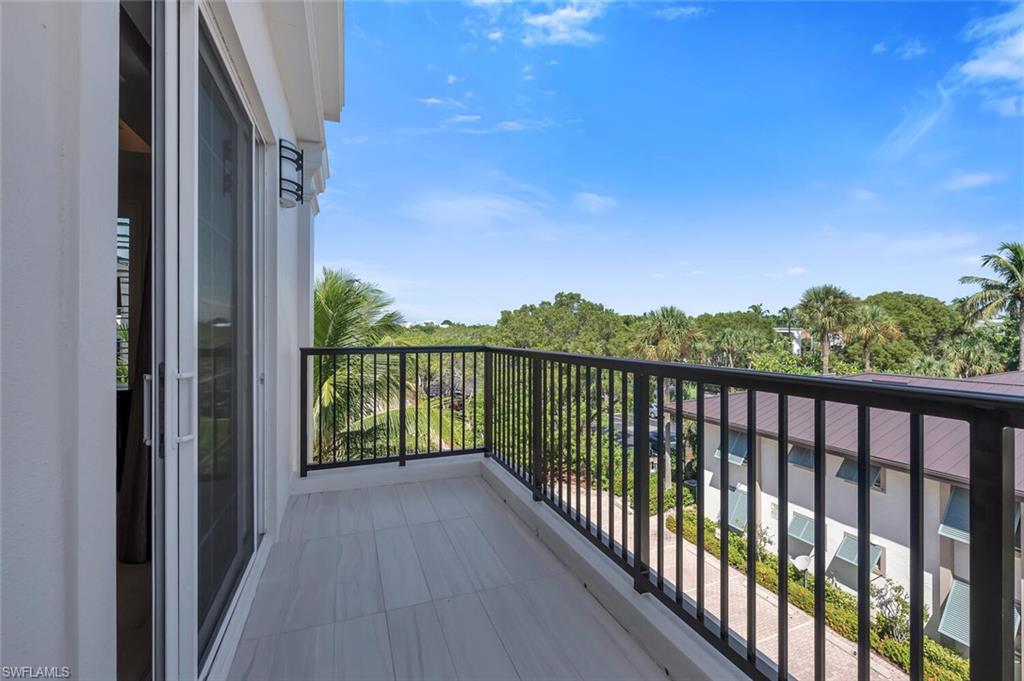 490 5th Street South, Unit 101 Naples, FL 34102 - Photo 25 of 50 a balcony with a lake view