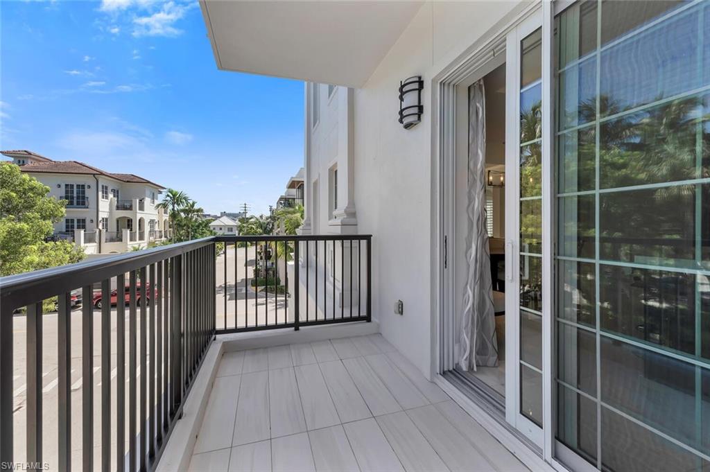 490 5th Street South, Unit 101 Naples, FL 34102 - Photo 28 of 50 a view of a balcony with wooden floor and fence