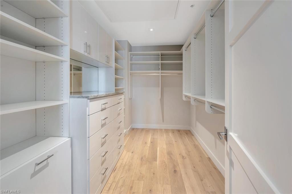 490 5th Street South, Unit 101 Naples, FL 34102 - Photo 32 of 50 a view of cabinets and wooden floor