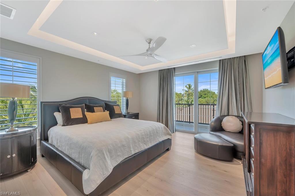 490 5th Street South, Unit 101 Naples, FL 34102 - Photo 34 of 50 a bedroom with a bed and a large window