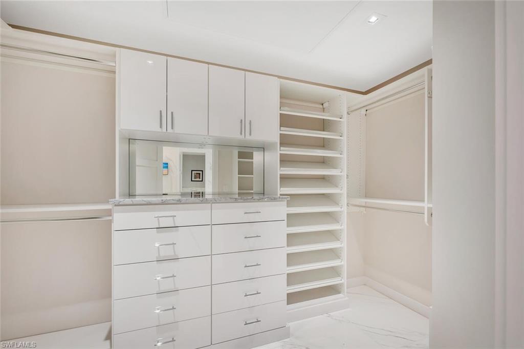 490 5th Street South, Unit 101 Naples, FL 34102 - Photo 39 of 50 a kitchen with cabinets appliances and a window