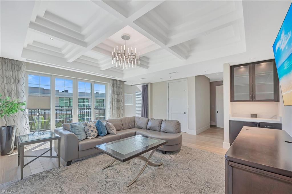490 5th Street South, Unit 101 Naples, FL 34102 - Photo 4 of 50 a living room with furniture and a large window