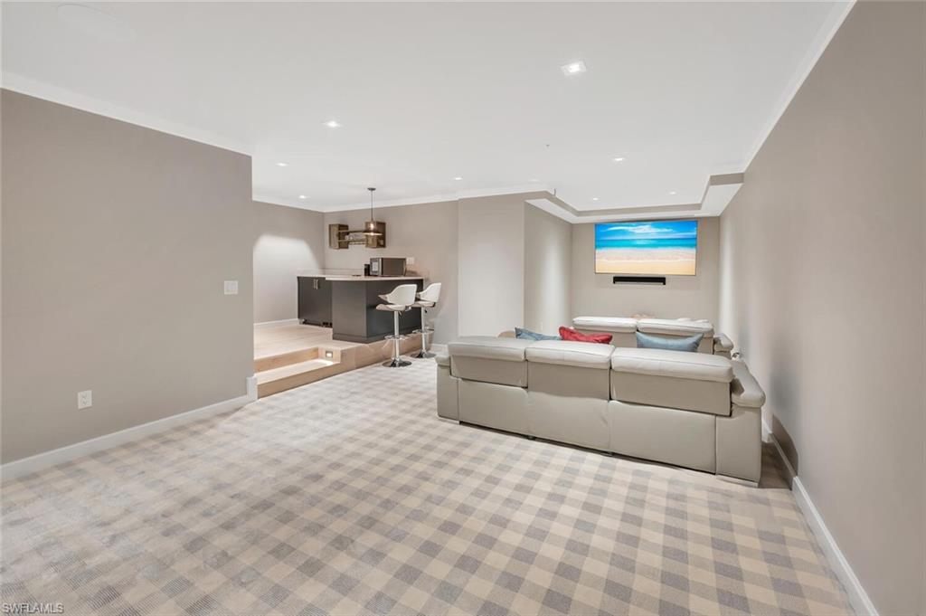 490 5th Street South, Unit 101 Naples, FL 34102 - Photo 41 of 50 a living room with furniture and a couch