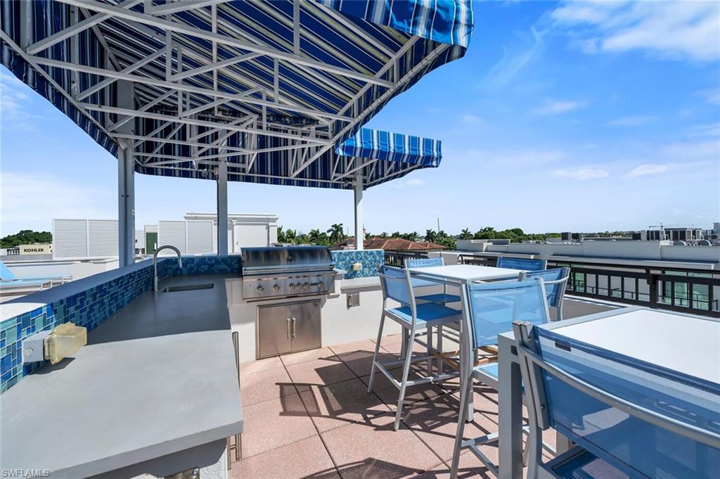 490 5th Street South, Unit 101 Naples, FL 34102 - Photo 49 of 50 a view of a chairs and table in patio