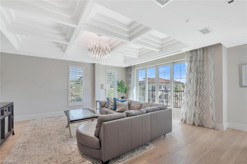 490 5th Street South, Unit 101 Naples, FL 34102 - Photo 5 of 50 a living room with furniture and a large window
