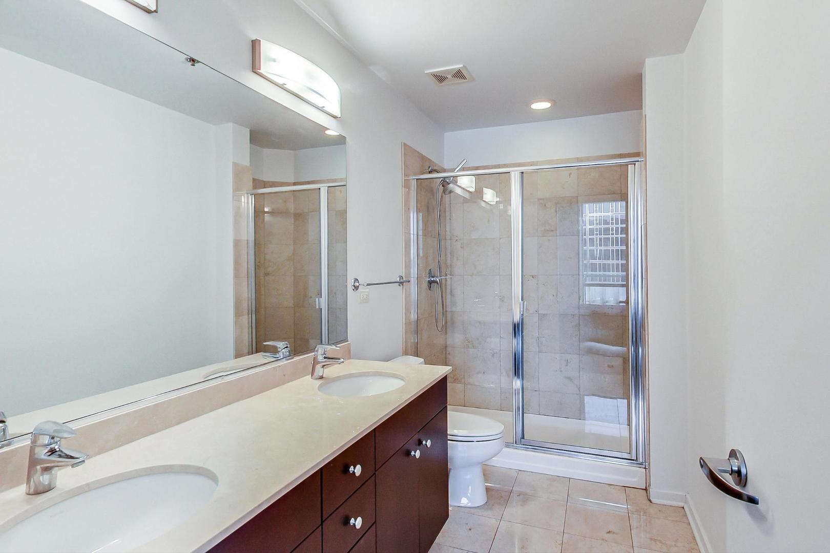 123 South Green Street, Unit 701B Chicago, IL 60607 - Photo 11 of 25 a bathroom with a granite countertop sink mirror and double