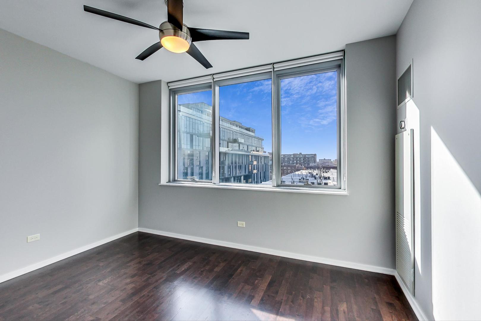 123 South Green Street, Unit 701B Chicago, IL 60607 - Photo 12 of 25 a view of an empty room with wooden floor and a window