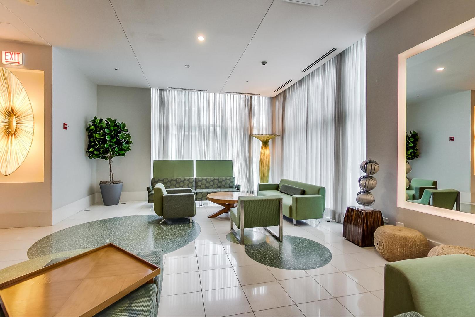123 South Green Street, Unit 701B Chicago, IL 60607 - Photo 20 of 25 a living room with furniture and a large window