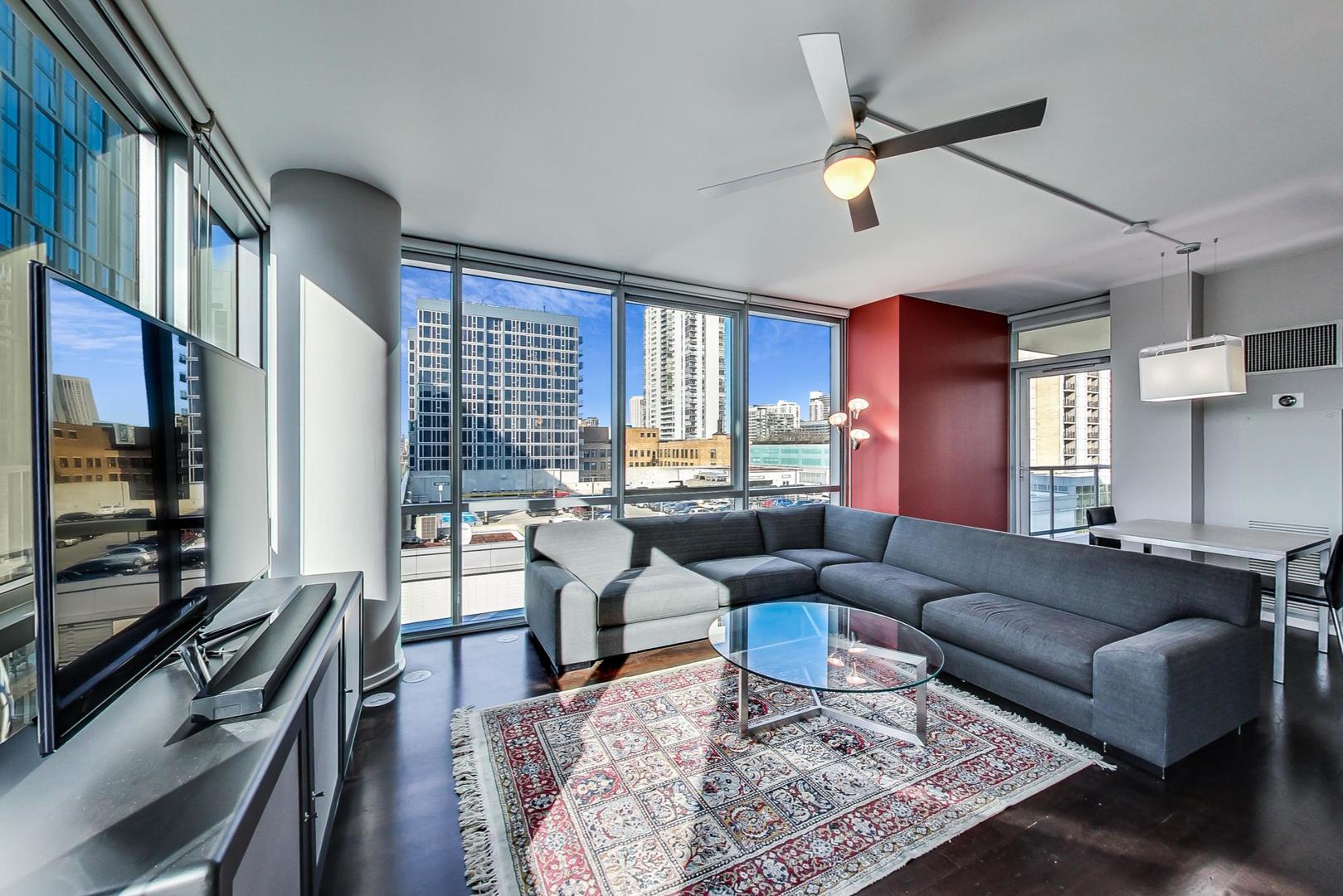 123 South Green Street, Unit 701B Chicago, IL 60607 - Photo 3 of 25 a living room with furniture and a flat screen tv