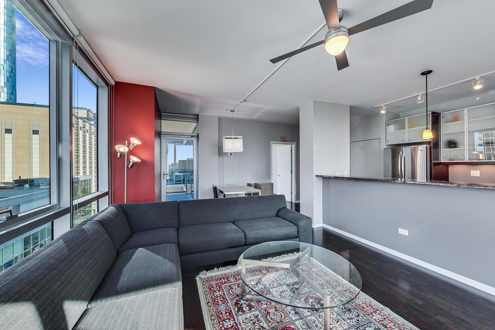 123 South Green Street, Unit 701B Chicago, IL 60607 - Photo 5 of 25 a living room with furniture and a chandelier