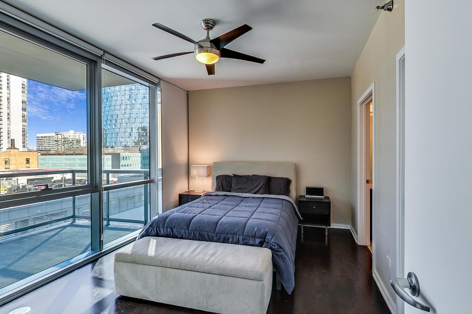 123 South Green Street, Unit 701B Chicago, IL 60607 - Photo 9 of 25 a bedroom with a bed and wooden floor