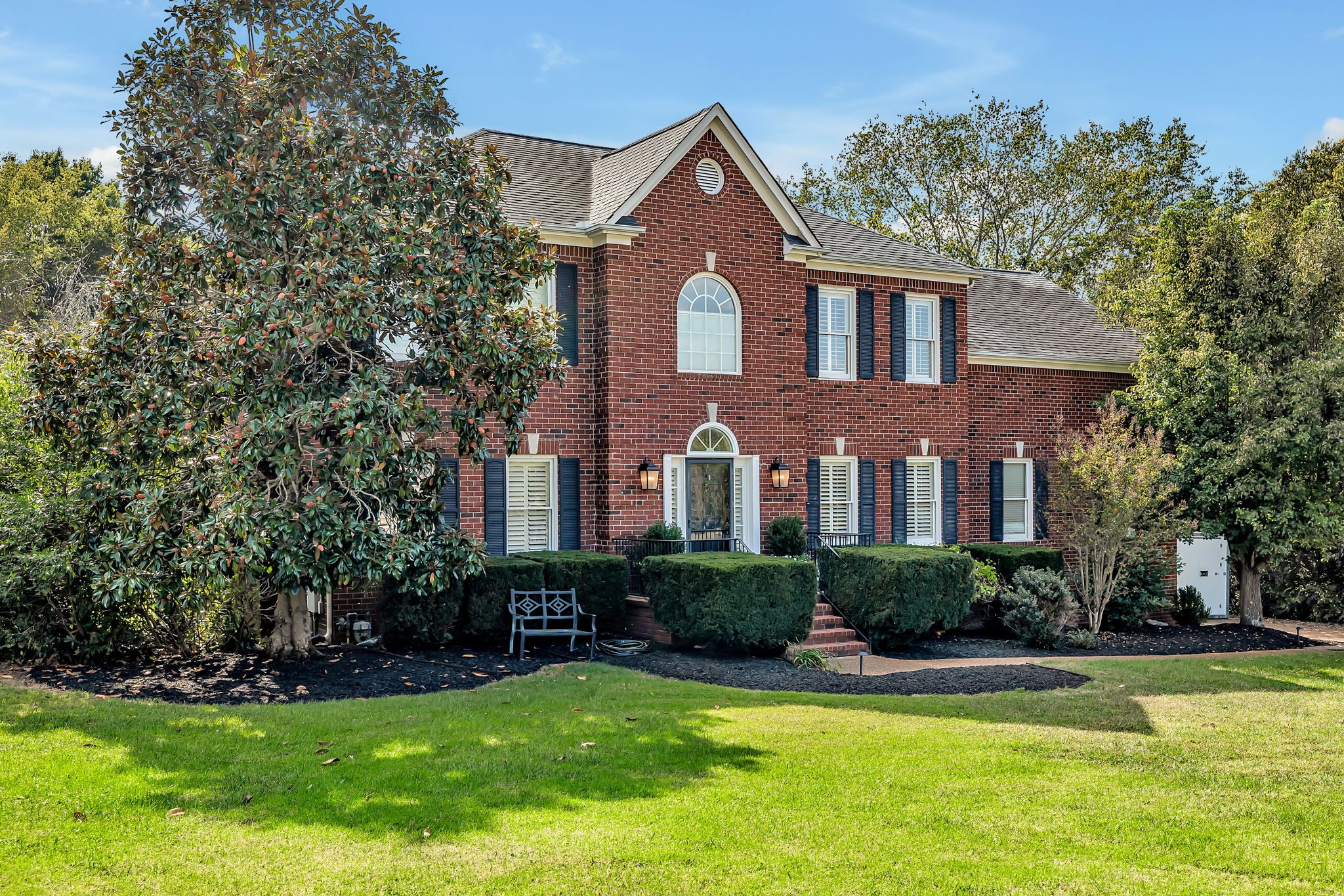 a front view of house with yard and green space
