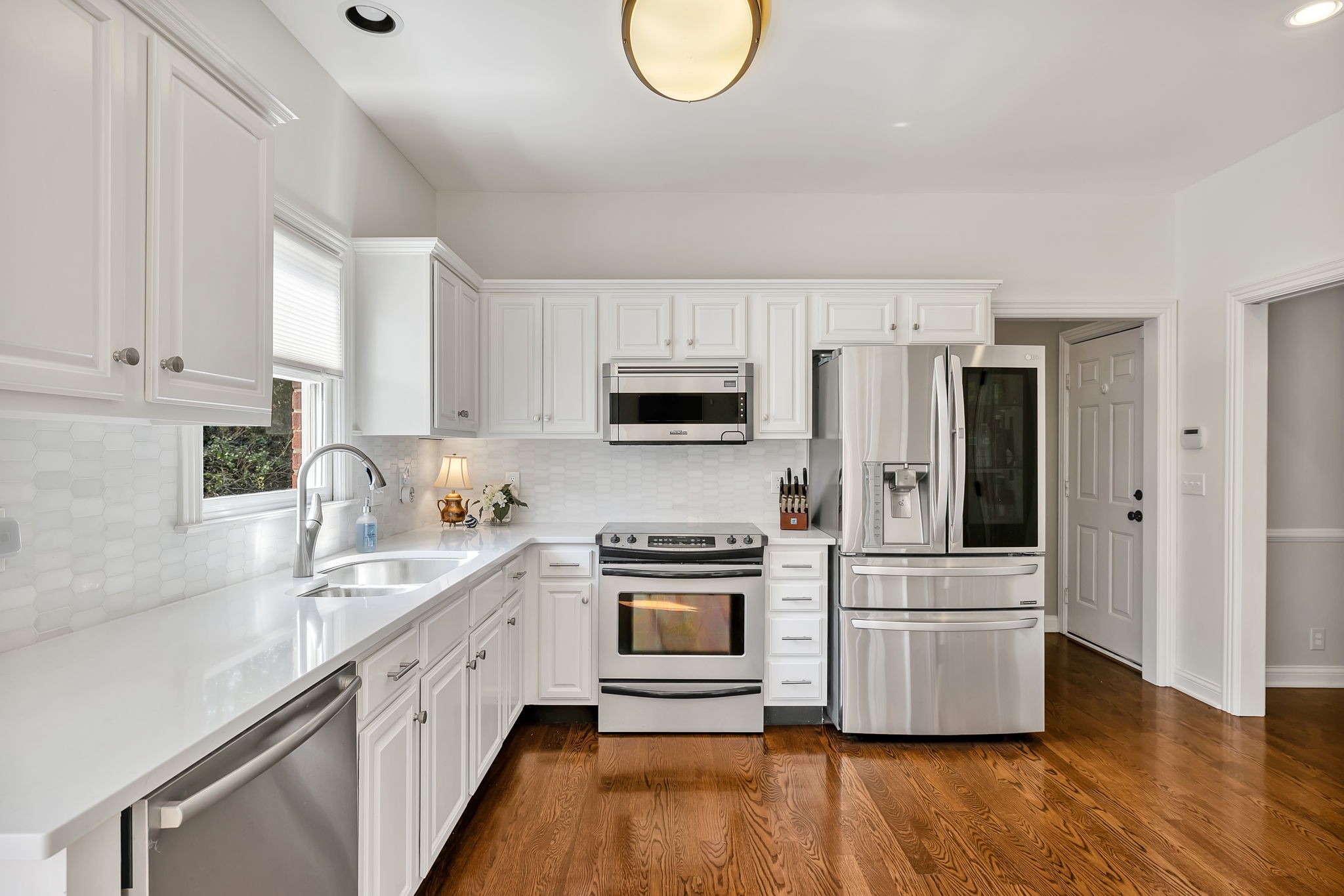 2829 Polo Club Road Nashville, TN 37221 - Photo 11 of 45 a kitchen with white cabinets and stainless steel appliances