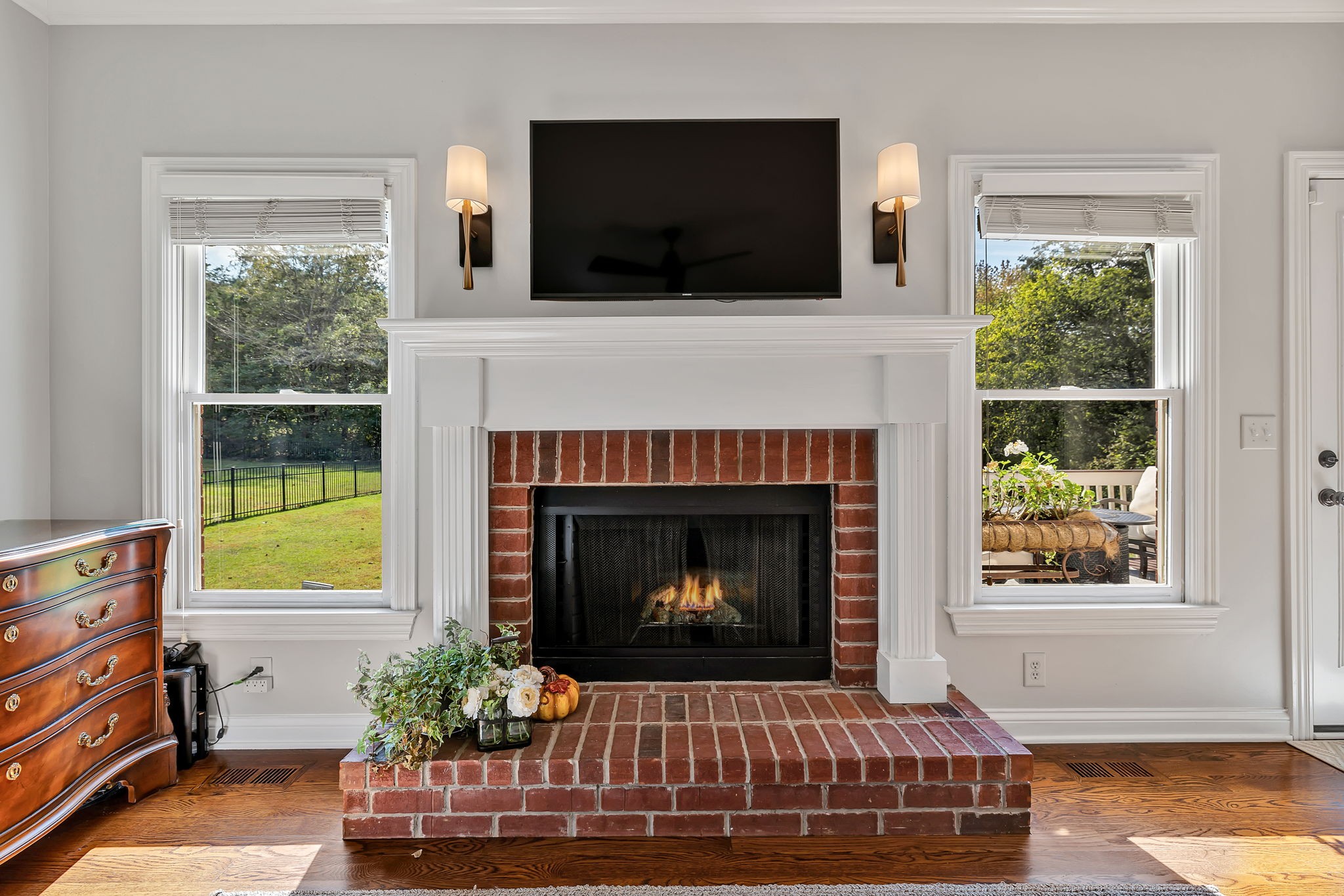 2829 Polo Club Road Nashville, TN 37221 - Photo 9 of 45 a living room with a fireplace a flat screen tv and a window
