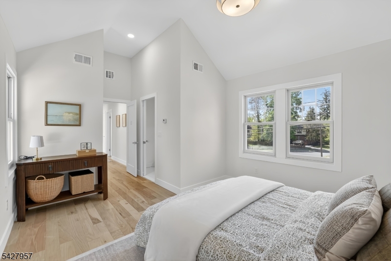 909 Ridgewood Road Millburn, NJ 07041 - Photo 13 of 33 a spacious bedroom with a bed and a window