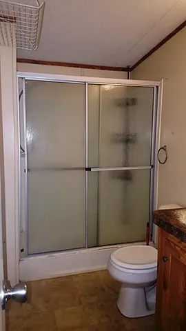 a bathroom with a toilet and a shower