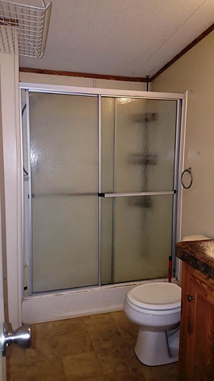 13289 Fm 2432 Road Willis, TX 77378 - Photo 6 of 7 a bathroom with a toilet and a shower