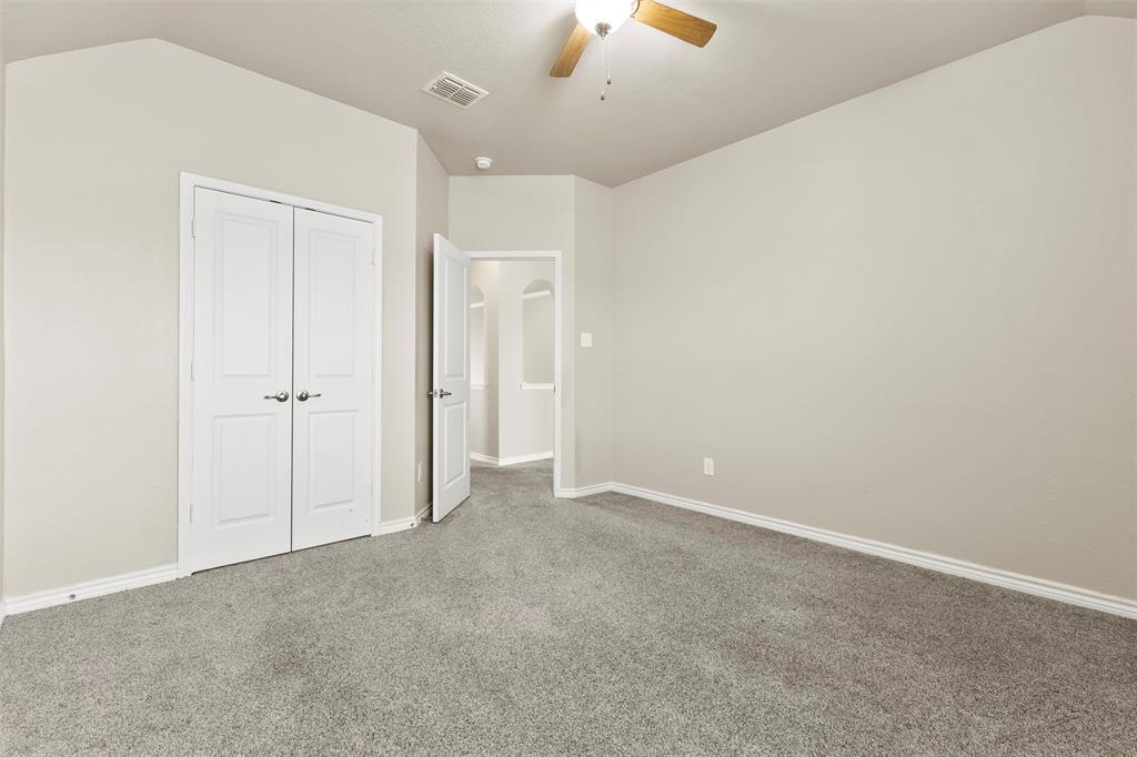 6522 Portside Ridge Lane Dallas, TX 75249 - Photo 22 of 37 Carpeted room featuring vaulted ceilings, a ceiling fan, baseboard molding, and double-panel doors