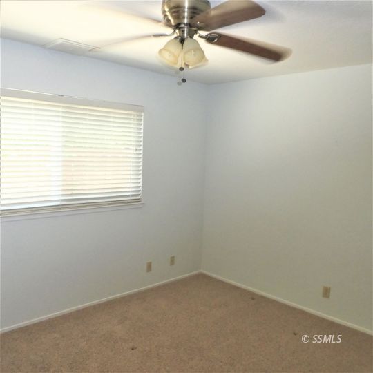 1104 North Inyo Street Ridgecrest, CA 93555 - Photo 17 of 31 an empty room with a window and a fan