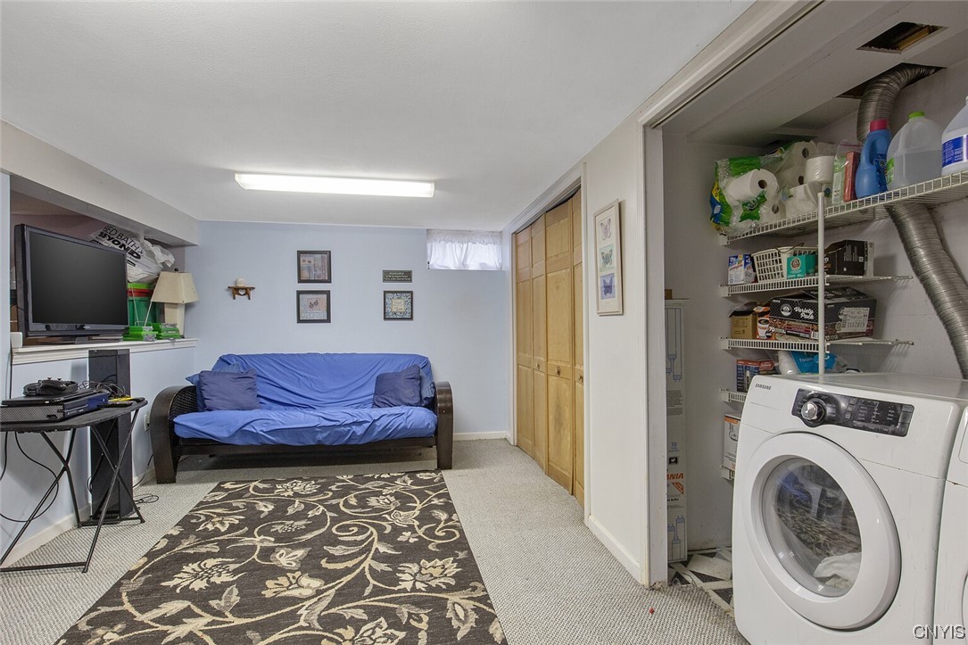 8185 Rizzo Drive Clay, NY 13041 - Photo 25 of 28 Finished basement space. Laundry area to the right