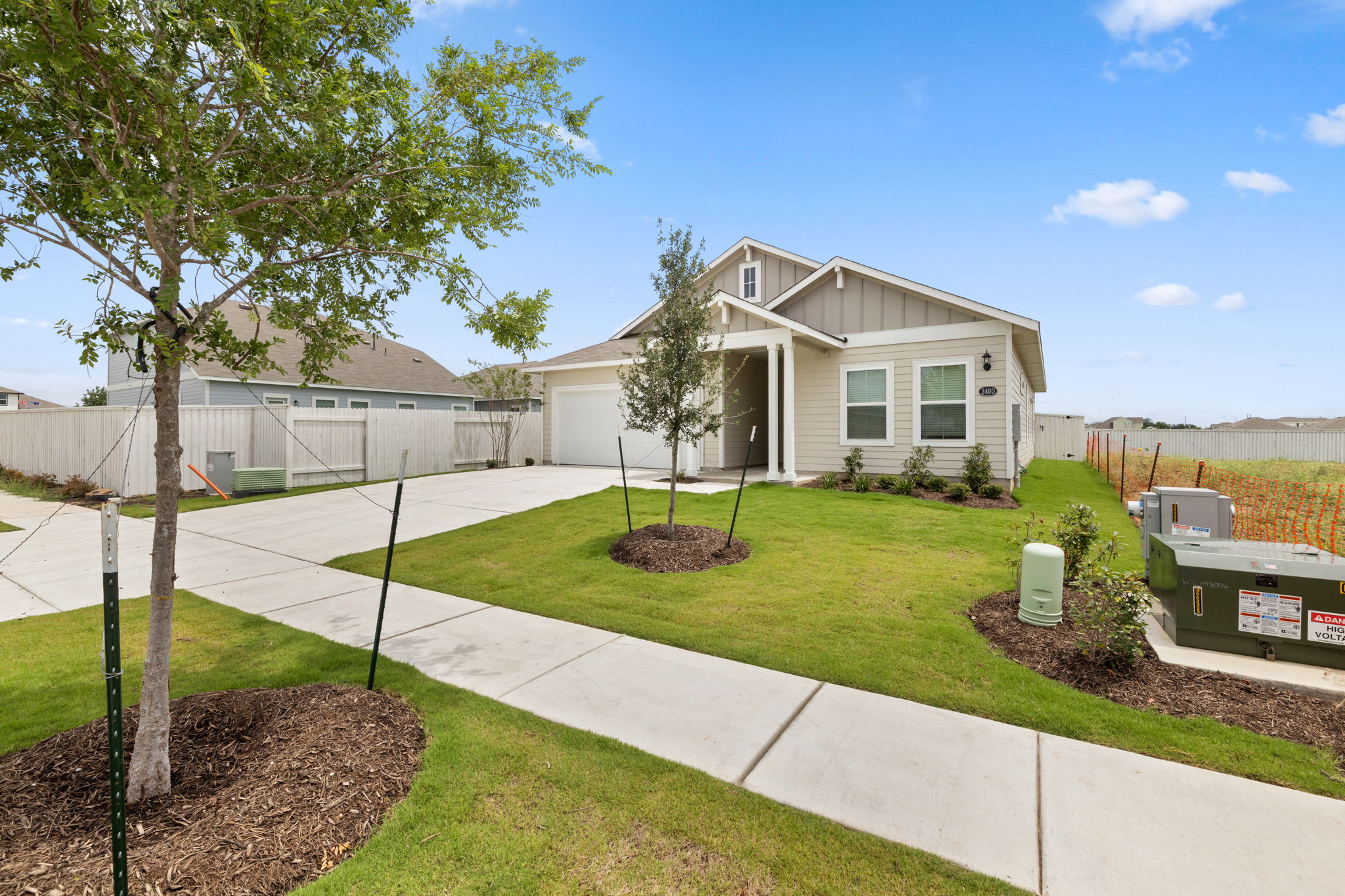 2460 Winding Creek Road Kyle, TX 78640 - Photo 2 of 20 A newly constructed residence features tidy landscaping, a concrete driveway, and inviting front porch.