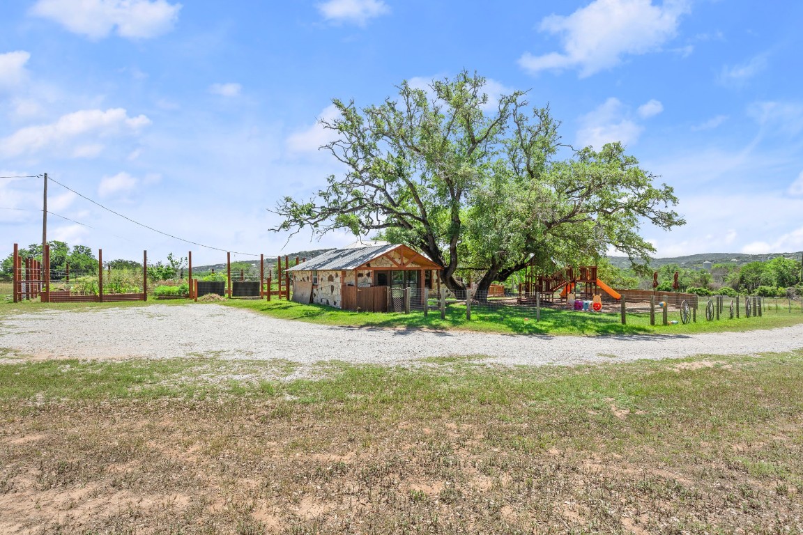 525 Pace Bend Road North Spicewood, TX 78669 - Photo 26 of 28 a view of a house with a yard and large trees