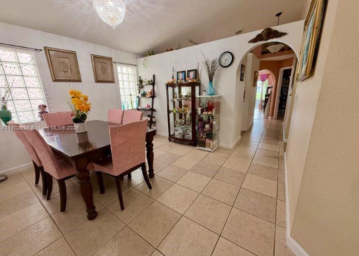 21316 Southwest 87th Place Cutler Bay, FL 33189 - Photo 8 of 14 a dining room with furniture and window