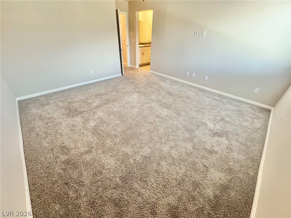7020 Colonial Ranch Street Las Vegas, NV 89166 - Photo 9 of 37 Soft plush carpeting runs throughout this bedroom suite leading directly to the master bathroom.