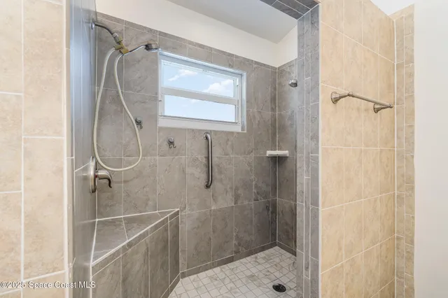 a bathroom with a glass shower door