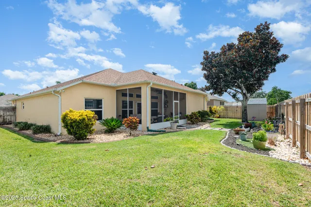 a view of a house with backyard sitting area and garden